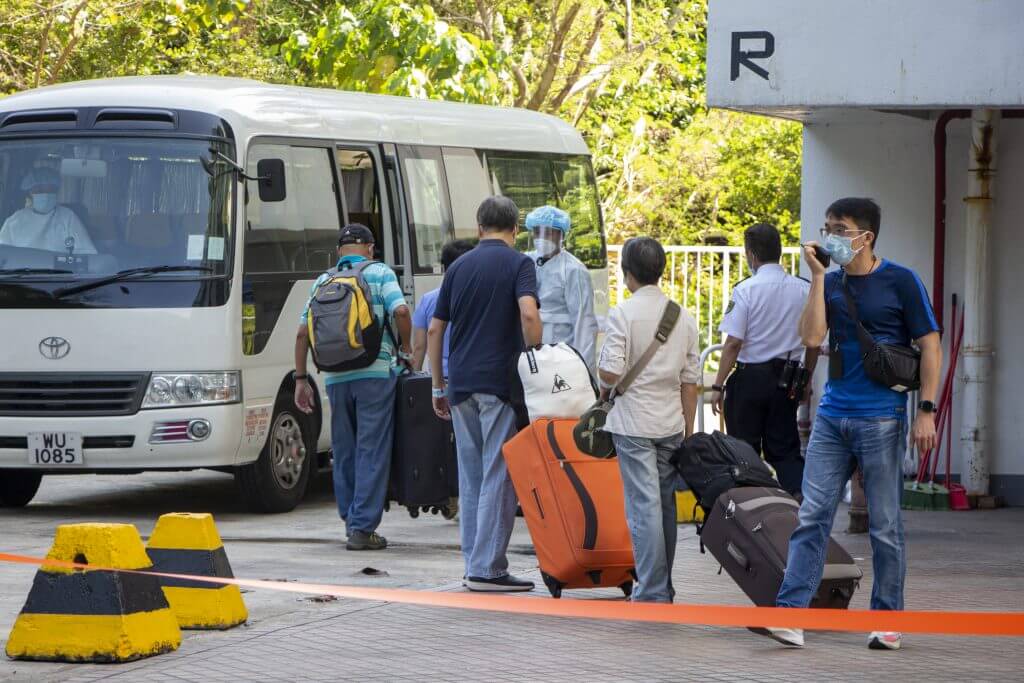 Residents leave the Tsuen Wan building for government-mandated quarantine. 